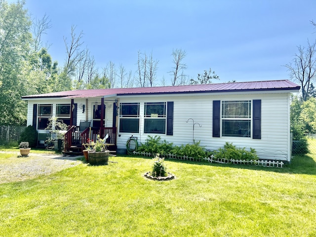 1604 Harrison Ave, Cheboygan, MI 49721 - view of front of house with a front lawn and a metal roof