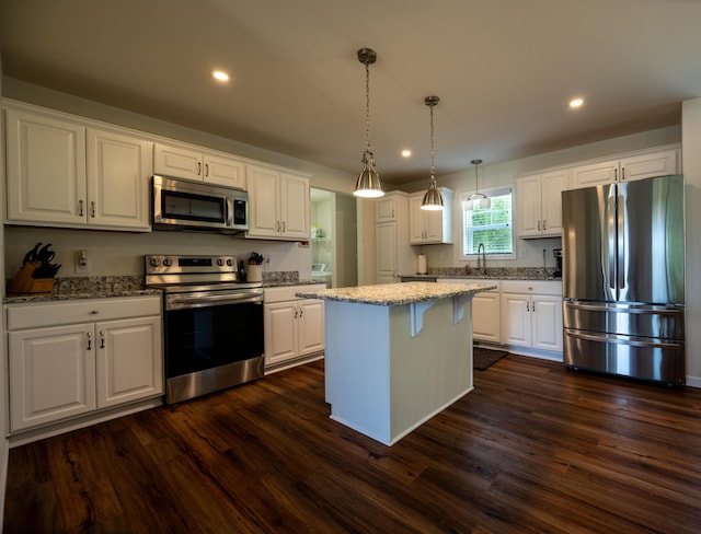 1817 Lindburgh Ln, Cheboygan, MI 49721 - kitchen featuring appliances with stainless steel finishes, white cabinets, dark wood-style floors, light stone counters, and recessed lighting