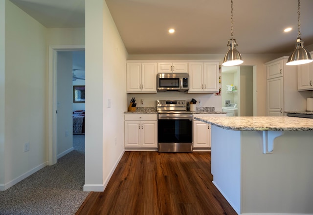1817 Lindburgh Ln, Cheboygan, MI 49721 - kitchen featuring stainless steel appliances, white cabinets, recessed lighting, light stone countertops, and dark wood-type flooring