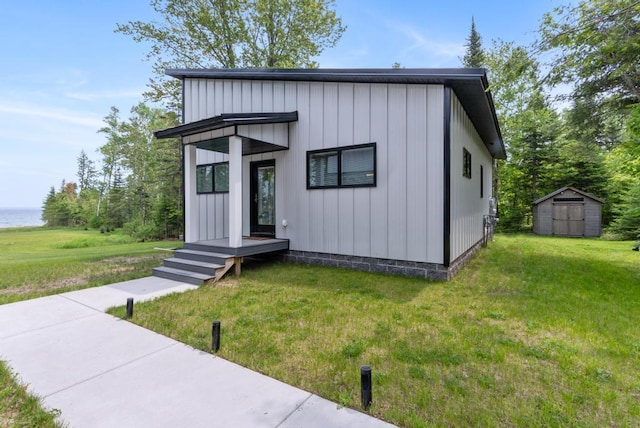 2960 W US-23 Hwy, Cheboygan, MI 49721 - view of front of house with a front lawn, a storage shed, and a water view