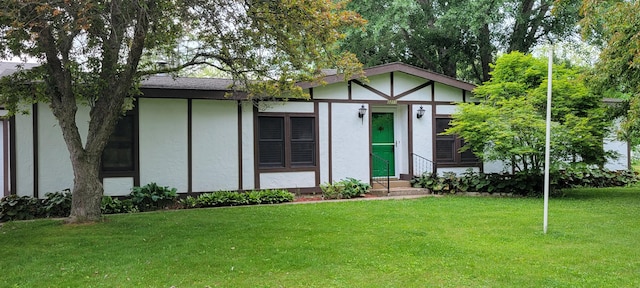 3211 S Partridge Point Rd, Alpena, MI 49707 - view of front of property featuring entry steps, stucco siding, and a front lawn