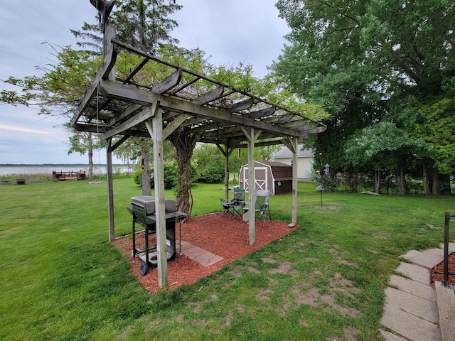 3211 S Partridge Point Rd, Alpena, MI 49707 - view of grassy yard featuring a shed, a pergola, and a water view