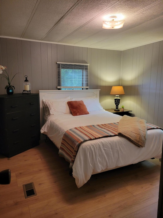 3211 S Partridge Point Rd, Alpena, MI 49707 - bedroom with wood finished floors and a textured ceiling