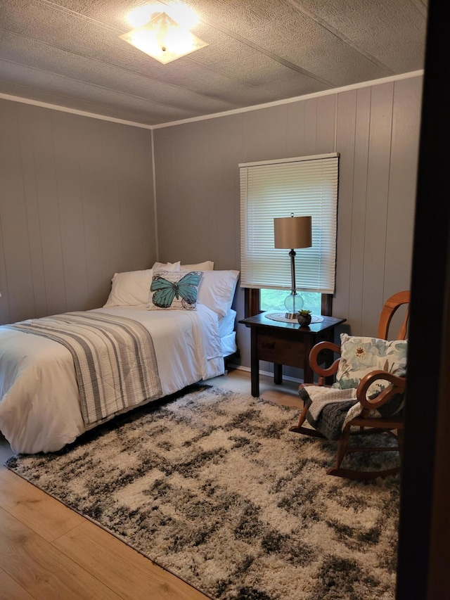 3211 S Partridge Point Rd, Alpena, MI 49707 - bedroom featuring wood finished floors, ornamental molding, and a textured ceiling