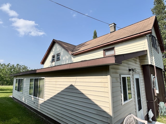 7770 Klein Rd, Hillman, MI 49746 - view of side of home featuring a chimney