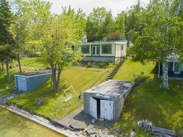 9319 Blue Horizon Rd, Presque Isle, MI 49777 - view of front facade with a front lawn and a storage unit