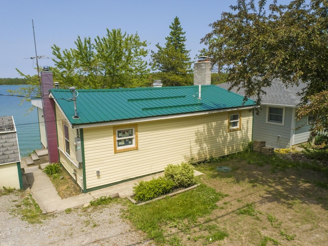 9319 Blue Horizon Rd, Presque Isle, MI 49777 - back of property with a chimney and a metal roof