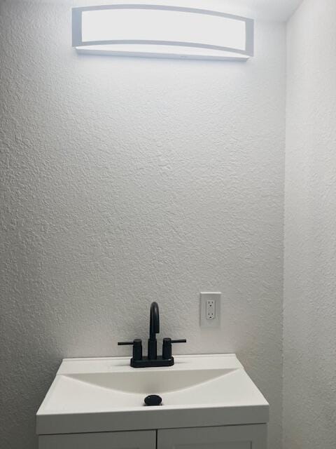9319 Blue Horizon Rd, Presque Isle, MI 49777 - bathroom with a textured wall and vanity