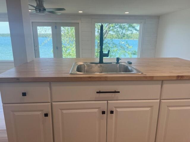 9319 Blue Horizon Rd, Presque Isle, MI 49777 - kitchen with white cabinets, a ceiling fan, and recessed lighting