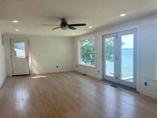 9319 Blue Horizon Rd, Presque Isle, MI 49777 - empty room featuring wood finished floors, ceiling fan, wooden walls, and recessed lighting