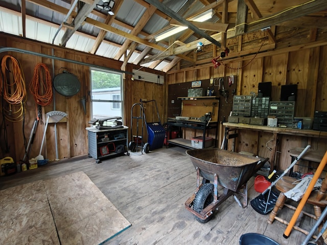 3178 Tobias Rd, Elmira, MI 49730 - garage with wood walls and a workshop area