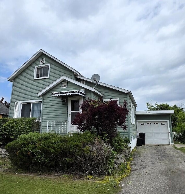 510 W Baldwin St, Alpena, MI 49707 - view of side of property with an attached garage and asphalt driveway