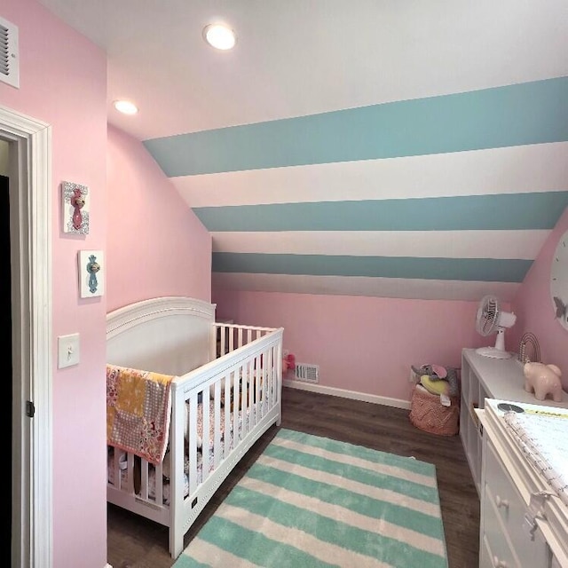 510 W Baldwin St, Alpena, MI 49707 - bedroom featuring recessed lighting, vaulted ceiling, dark wood finished floors, and a crib