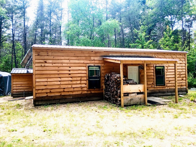 5228 S Brown Rd, Cadillac, MI 49601 - view of front of house featuring a metal roof and an outbuilding