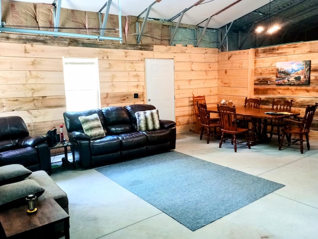 5228 S Brown Rd, Cadillac, MI 49601 - living room with concrete floors, wood walls, and a high ceiling