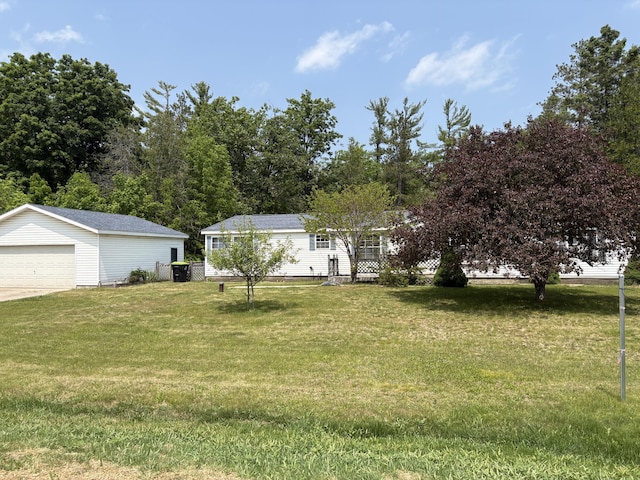 348 Lake Winyah Rd, Alpena, MI 49707 - view of grassy yard with an outbuilding and a garage