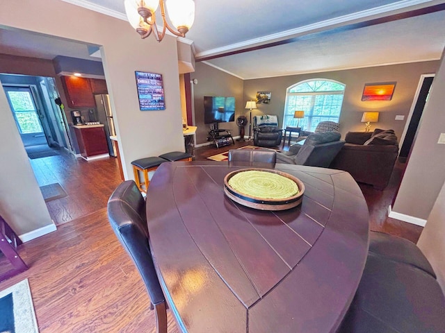 5514 N Bay Ct, Presque Isle, MI 49777 - dining area with crown molding, wood finished floors, healthy amount of natural light, and a chandelier