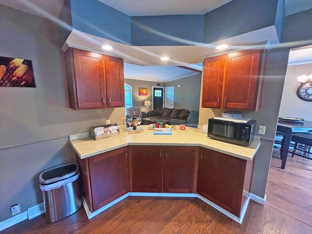 5514 N Bay Ct, Presque Isle, MI 49777 - kitchen with black microwave, dark wood-style flooring, light countertops, a peninsula, and open floor plan