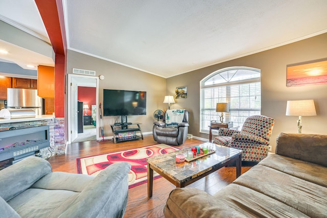 5514 N Bay Ct, Presque Isle, MI 49777 - living area with ornamental molding, lofted ceiling, and wood finished floors
