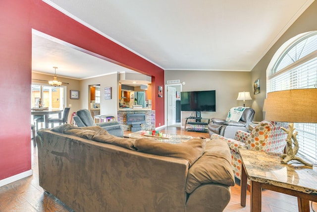 5514 N Bay Ct, Presque Isle, MI 49777 - living area featuring plenty of natural light, a chandelier, ornamental molding, and wood finished floors