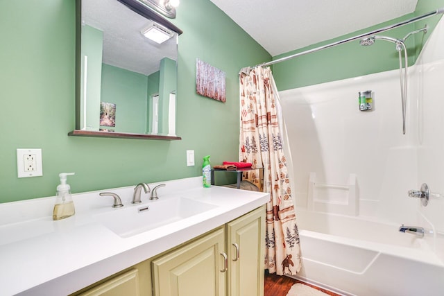 5514 N Bay Ct, Presque Isle, MI 49777 - full bath featuring vanity, shower / bath combo with shower curtain, wood finished floors, and a textured ceiling