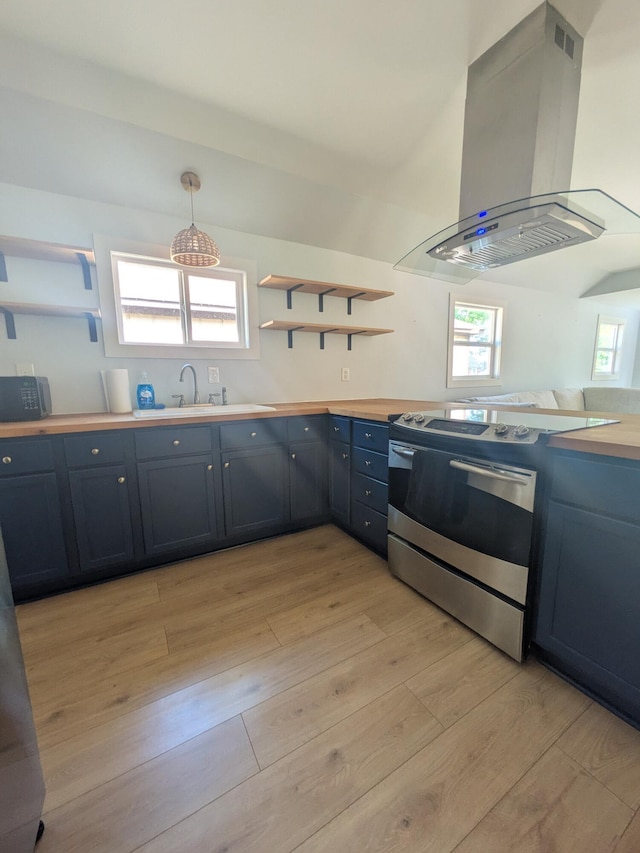 114 Pine St, Prudenville, MI 48651 - kitchen with stainless steel electric range oven, island exhaust hood, open shelves, and light wood-style floors