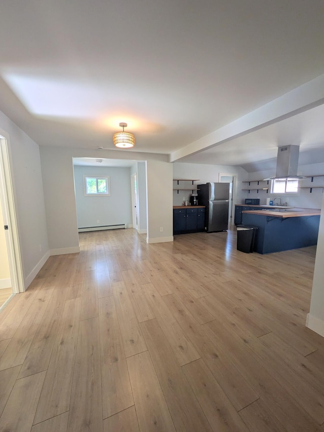 114 Pine St, Prudenville, MI 48651 - unfurnished living room featuring light wood finished floors and baseboard heating