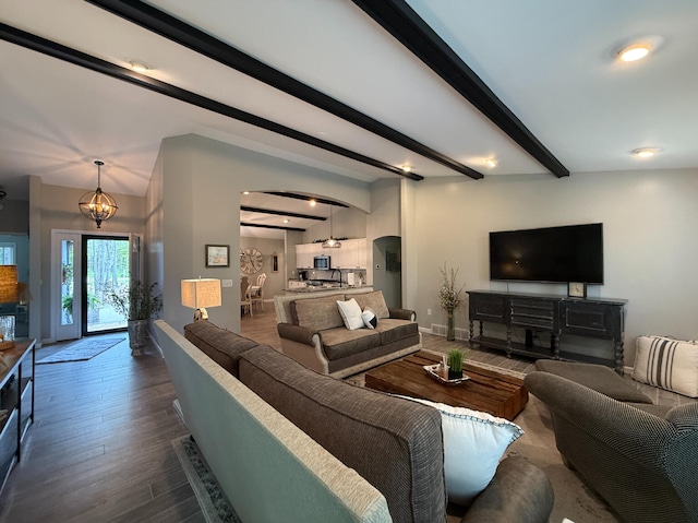 108 Bourbon St, Roscommon, MI 48653 - living area featuring arched walkways, beamed ceiling, dark wood finished floors, and recessed lighting