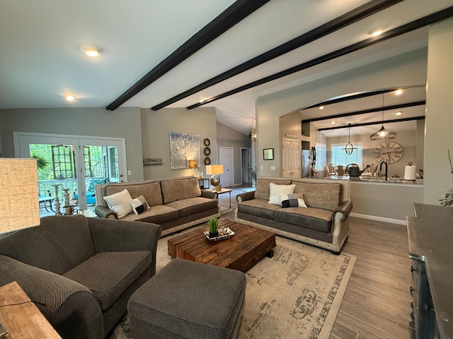 108 Bourbon St, Roscommon, MI 48653 - living room with wood finished floors, plenty of natural light, beam ceiling, and recessed lighting