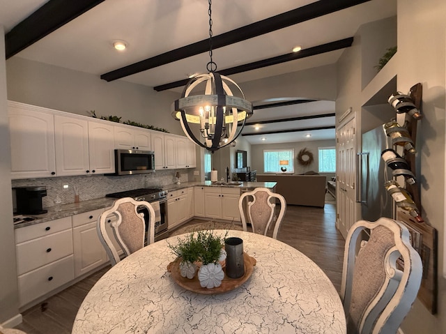 108 Bourbon St, Roscommon, MI 48653 - dining room featuring a chandelier, dark wood-type flooring, and beam ceiling