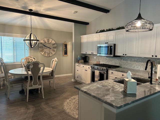108 Bourbon St, Roscommon, MI 48653 - kitchen with stainless steel appliances, decorative backsplash, and white cabinets