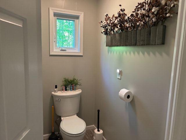 108 Bourbon St, Roscommon, MI 48653 - bathroom featuring baseboards and toilet