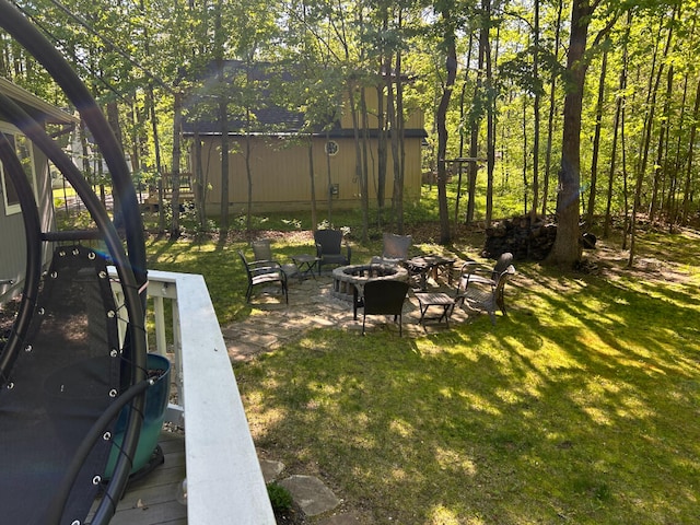 108 Bourbon St, Roscommon, MI 48653 - view of green lawn featuring an outdoor fire pit