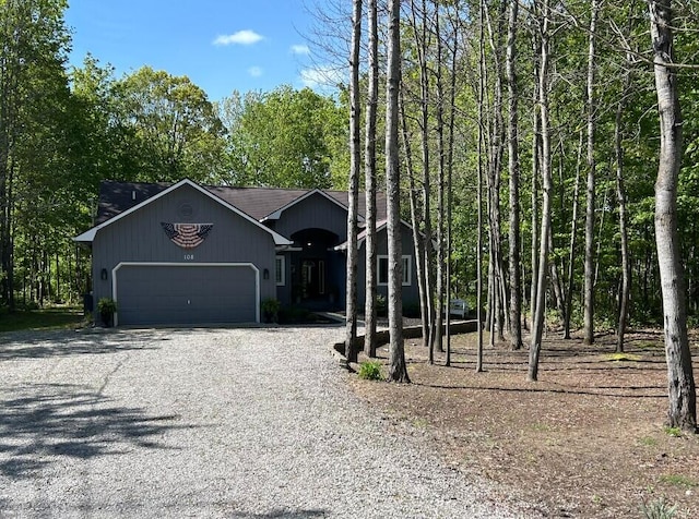 108 Bourbon St, Roscommon, MI 48653 - view of front facade with gravel driveway and a garage