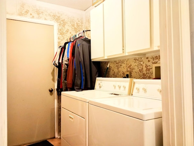 223 Mallard Ave, Houghton Lake, MI 48629 - laundry area featuring wallpapered walls, cabinet space, and washing machine and clothes dryer