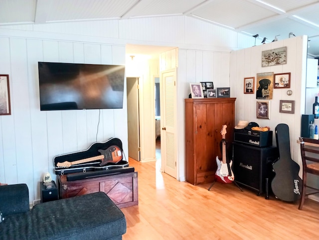 223 Mallard Ave, Houghton Lake, MI 48629 - living area featuring wood finished floors and vaulted ceiling