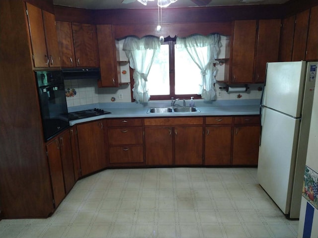 1427 E Lacomb Rd, Alpena, MI 49707 - kitchen with black appliances, light countertops, light flooring, under cabinet range hood, and ceiling fan