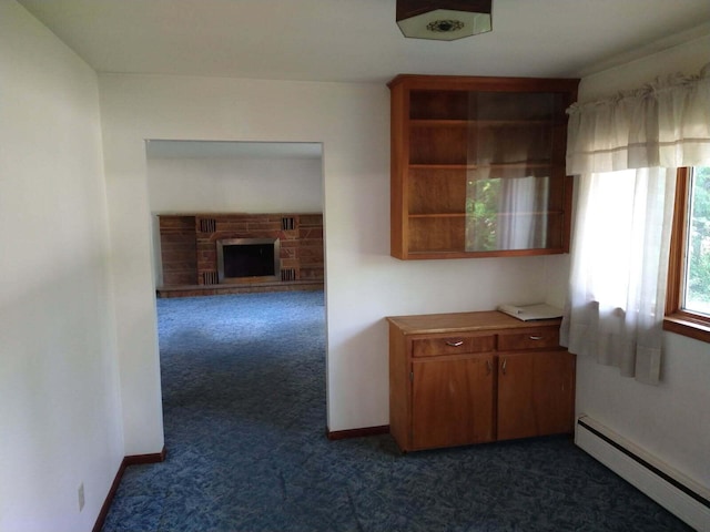 1427 E Lacomb Rd, Alpena, MI 49707 - corridor with baseboard heating and dark colored carpet