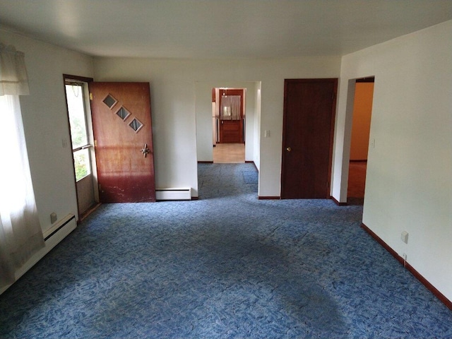1427 E Lacomb Rd, Alpena, MI 49707 - carpeted spare room featuring a baseboard heating unit and baseboards