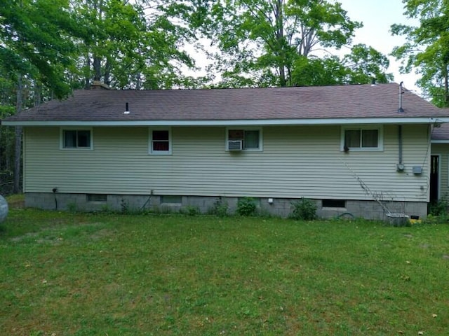 1427 E Lacomb Rd, Alpena, MI 49707 - view of home's exterior featuring a lawn and roof with shingles