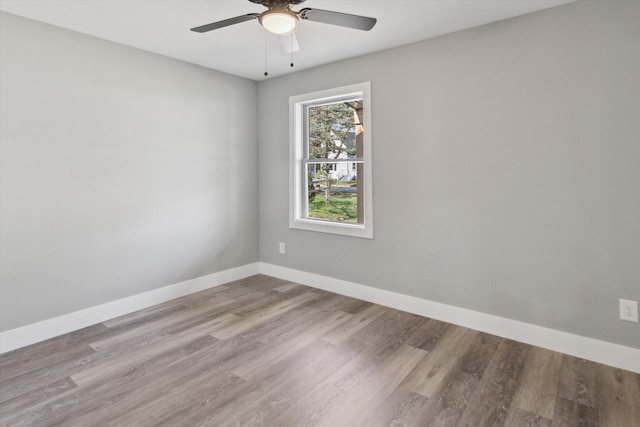 706 Colfax St, Cadillac, MI 49601 - empty room featuring a ceiling fan and wood finished floors