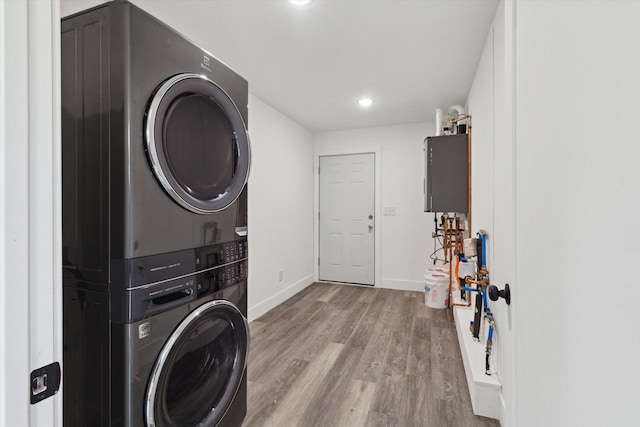 706 Colfax St, Cadillac, MI 49601 - washroom with stacked washer and clothes dryer, wood finished floors, and recessed lighting