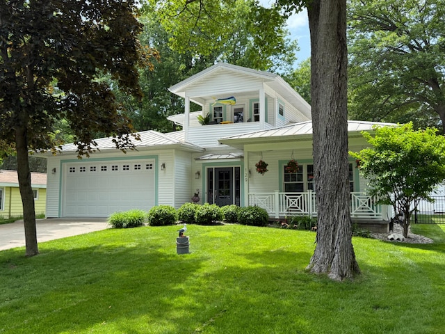 129 Ethel Dr, Roscommon, MI 48653 - view of front of property featuring a porch, a garage, driveway, a standing seam roof, and a metal roof