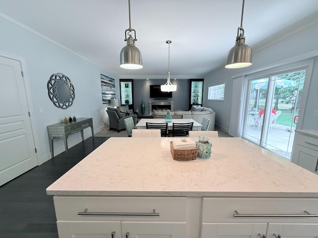 129 Ethel Dr, Roscommon, MI 48653 - kitchen with a fireplace, a kitchen island, white cabinets, dark wood finished floors, and light stone counters