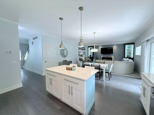 129 Ethel Dr, Roscommon, MI 48653 - kitchen featuring dark wood-style floors, a center island, hanging light fixtures, and white cabinetry