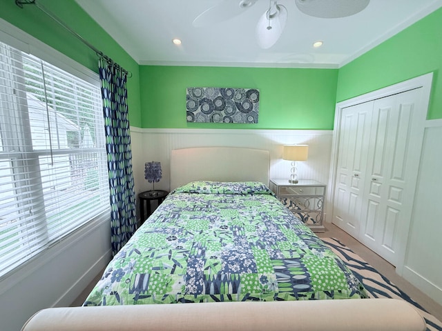 129 Ethel Dr, Roscommon, MI 48653 - carpeted bedroom with wainscoting, a closet, and ceiling fan