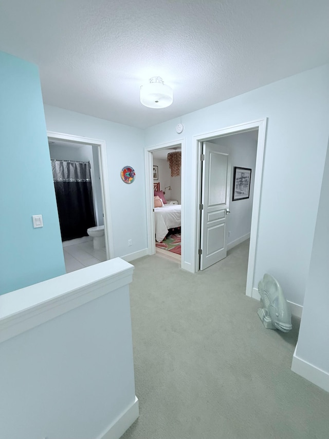 129 Ethel Dr, Roscommon, MI 48653 - corridor with a textured ceiling and light carpet