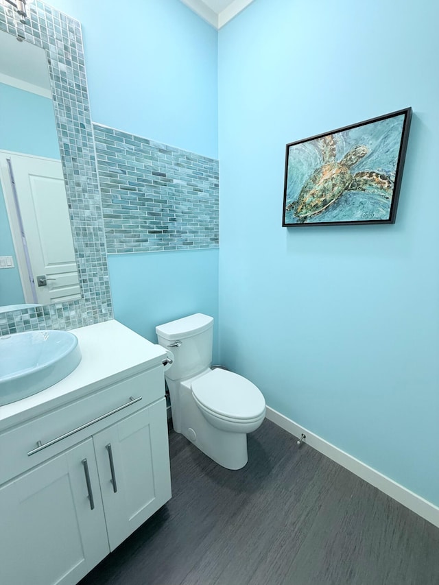 129 Ethel Dr, Roscommon, MI 48653 - half bath featuring tile walls, wood finished floors, vanity, and tasteful backsplash