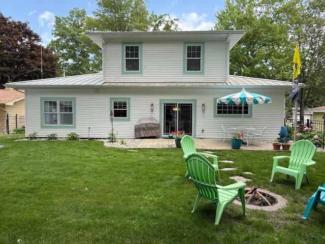 129 Ethel Dr, Roscommon, MI 48653 - rear view of house with a standing seam roof, an outdoor fire pit, a metal roof, and a wooden deck