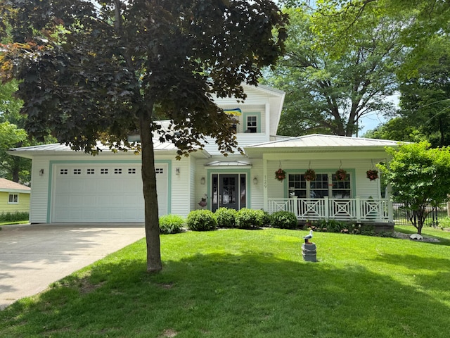 129 Ethel Dr, Roscommon, MI 48653 - view of front facade featuring covered porch, a front lawn, an attached garage, and concrete driveway